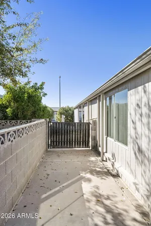 a view of a house with a small yard and wooden fence