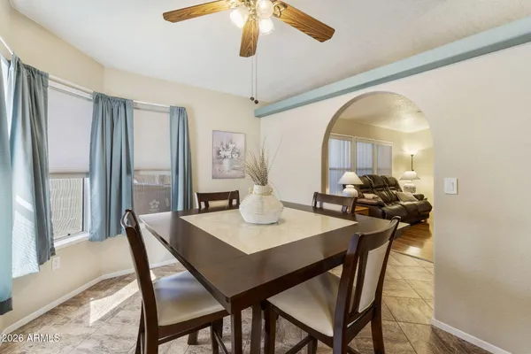 a view of a dining room with furniture and a chandelier
