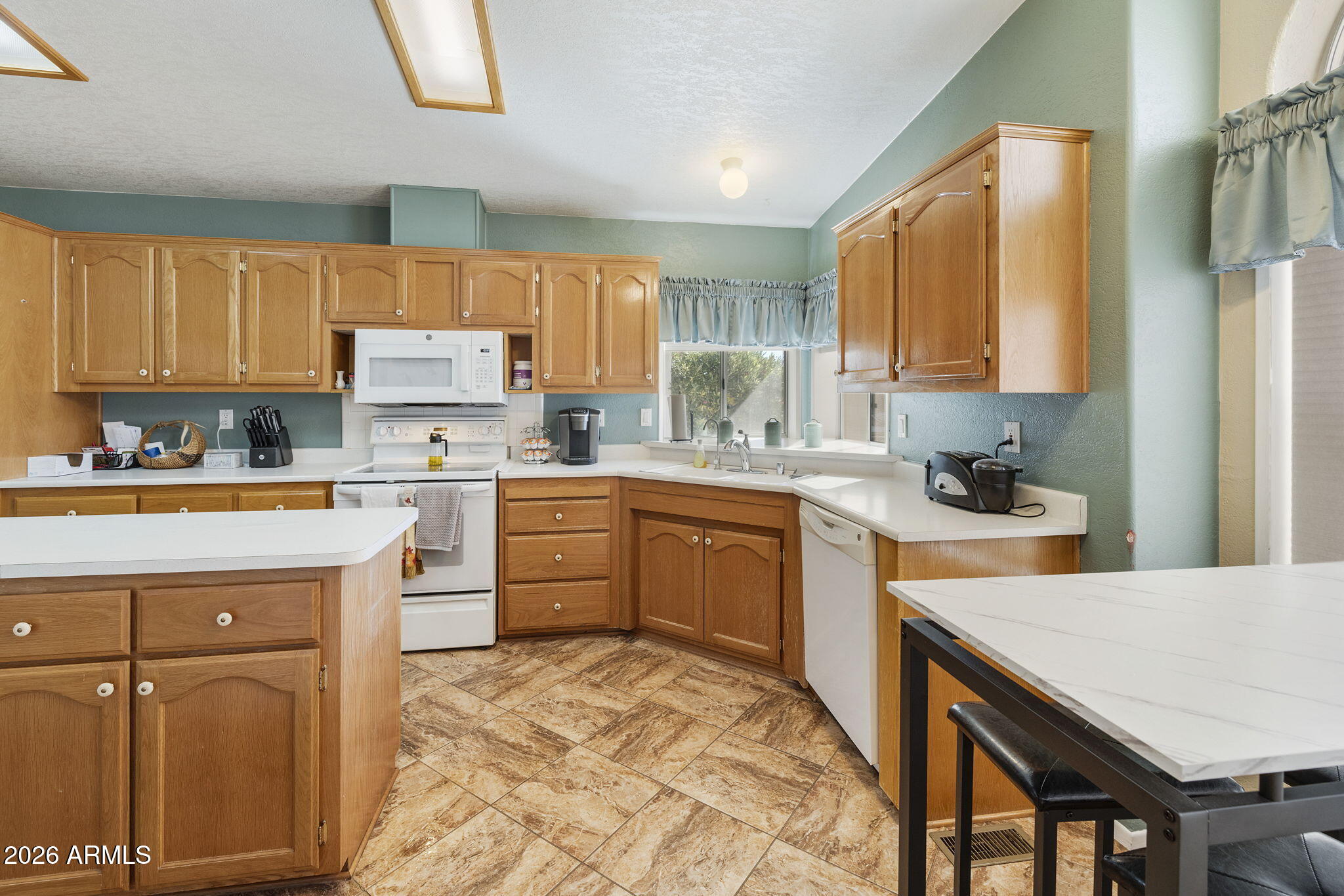 3700 South Tomahawk Road, Unit 23 Apache Junction, AZ 85119 - Photo 4 of 31 a kitchen with a sink a stove and cabinets