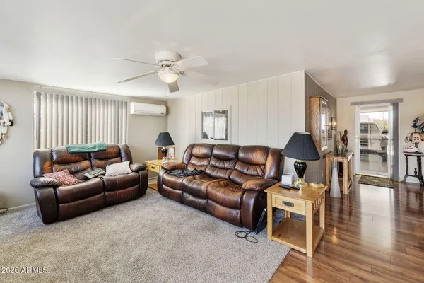 a living room with furniture and wooden floor