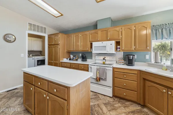 a kitchen with a refrigerator stove top oven and sink