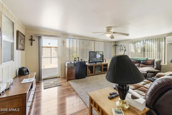 a living room with furniture a chandelier and a window