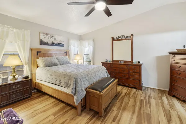 a bedroom with a bed and wooden floor
