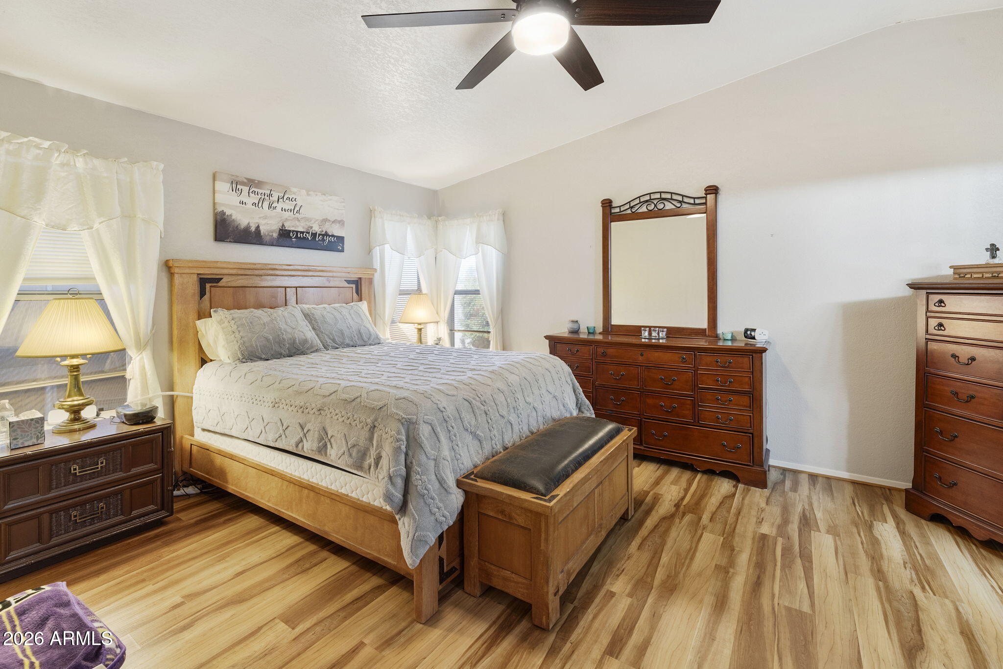 3700 South Tomahawk Road, Unit 23 Apache Junction, AZ 85119 - Photo 9 of 31 a bedroom with a bed and wooden floor