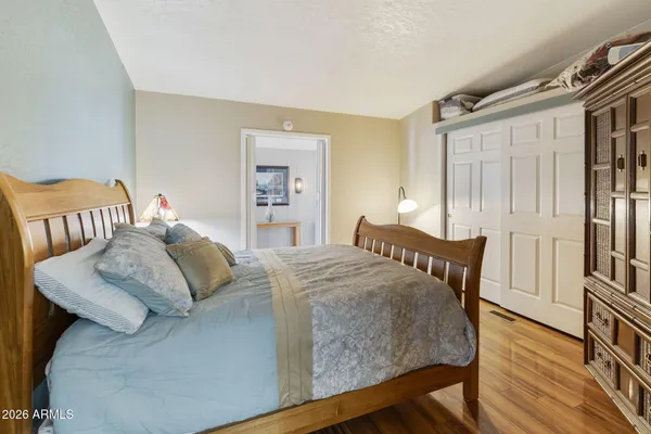 a bedroom with a bed and wooden floor
