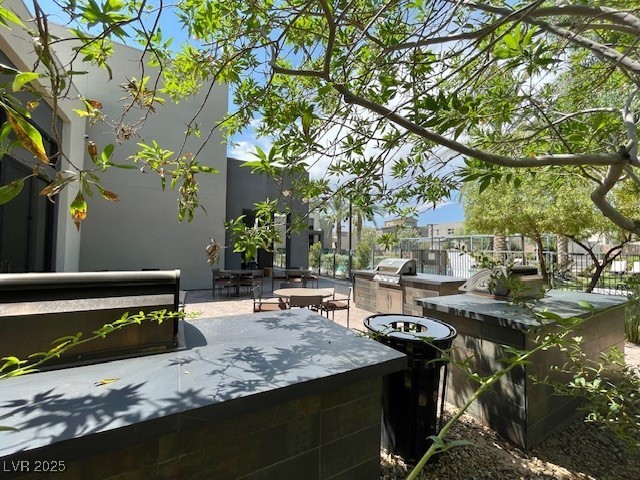 11238 Essence Point Avenue, Unit 210 Las Vegas, NV 89135 - Photo 14 of 28 View of patio / terrace with an outdoor kitchen