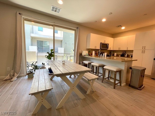 11238 Essence Point Avenue, Unit 210 Las Vegas, NV 89135 - Photo 16 of 28 Dining area featuring light wood-type flooring and recessed lighting