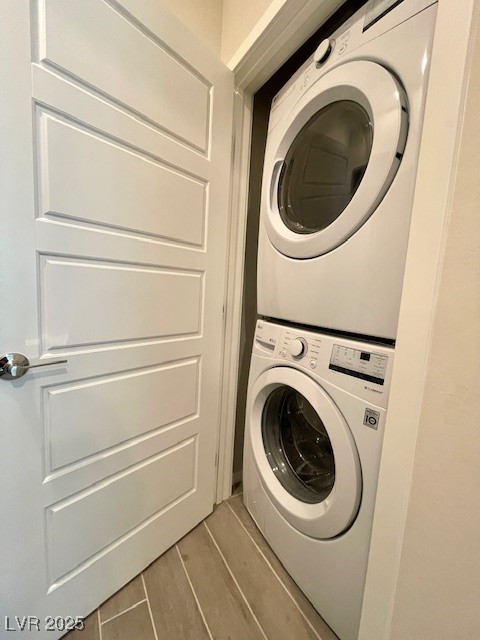 11238 Essence Point Avenue, Unit 210 Las Vegas, NV 89135 - Photo 21 of 28 Laundry area featuring wood finished floors and estacked washer and dryer