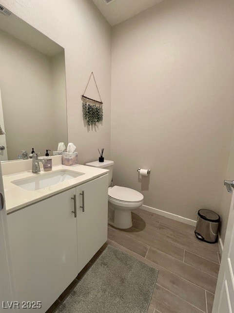11238 Essence Point Avenue, Unit 210 Las Vegas, NV 89135 - Photo 9 of 28 Half bathroom with vanity and baseboards