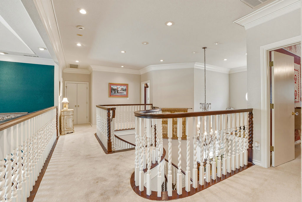 1009 Southeast County Road Ada, OK 74820 - Photo 36 of 92 Carpeted landing featuring recessed lighting, crown molding, and a baluster railing with a dark wood-finish handrail