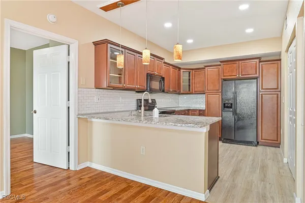 a kitchen with stainless steel appliances granite countertop a refrigerator and a sink