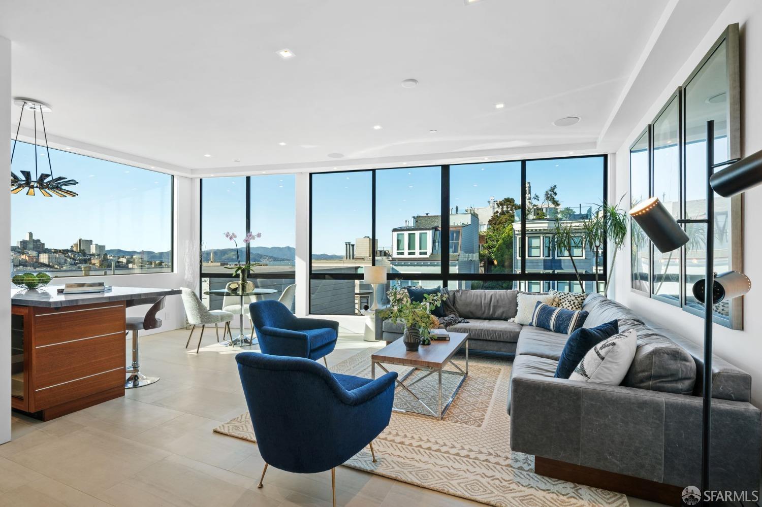 a living room with furniture large windows and a view of lake