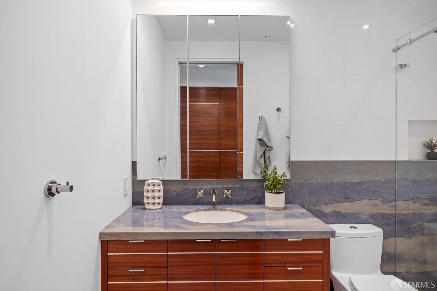 455 Vallejo Street, Unit PH6 San Francisco, CA 94133 - Photo 17 of 45 a bathroom with a granite countertop sink and a mirror