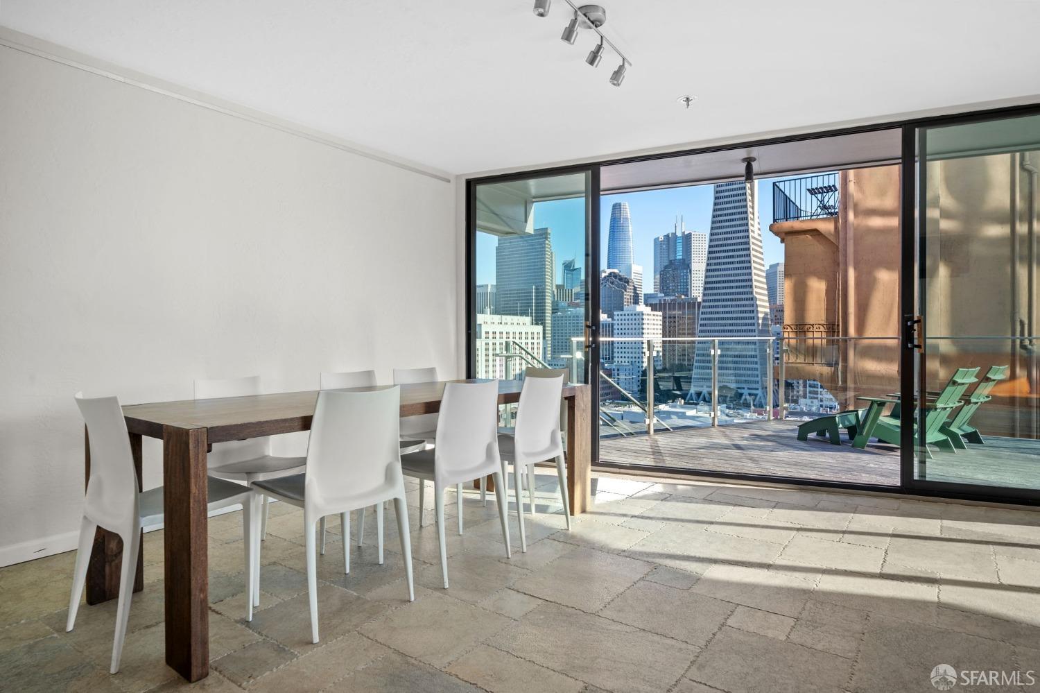 455 Vallejo Street, Unit PH6 San Francisco, CA 94133 - Photo 21 of 45 a dining room with furniture and a floor to ceiling window