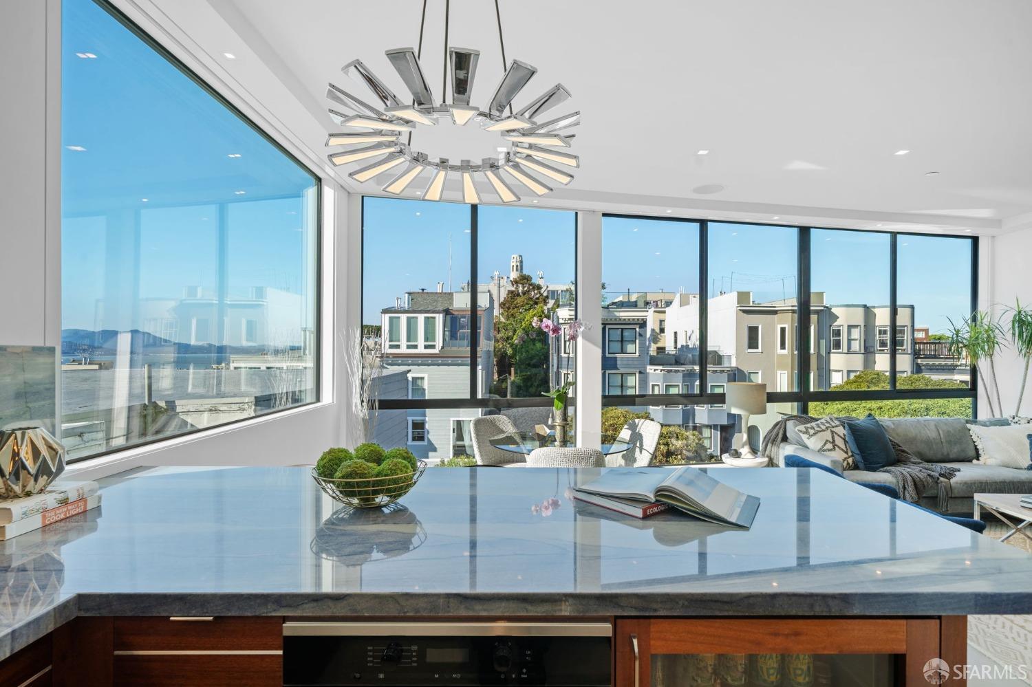 455 Vallejo Street, Unit PH6 San Francisco, CA 94133 - Photo 6 of 45 a view of a dining room with furniture a chandelier and large windows