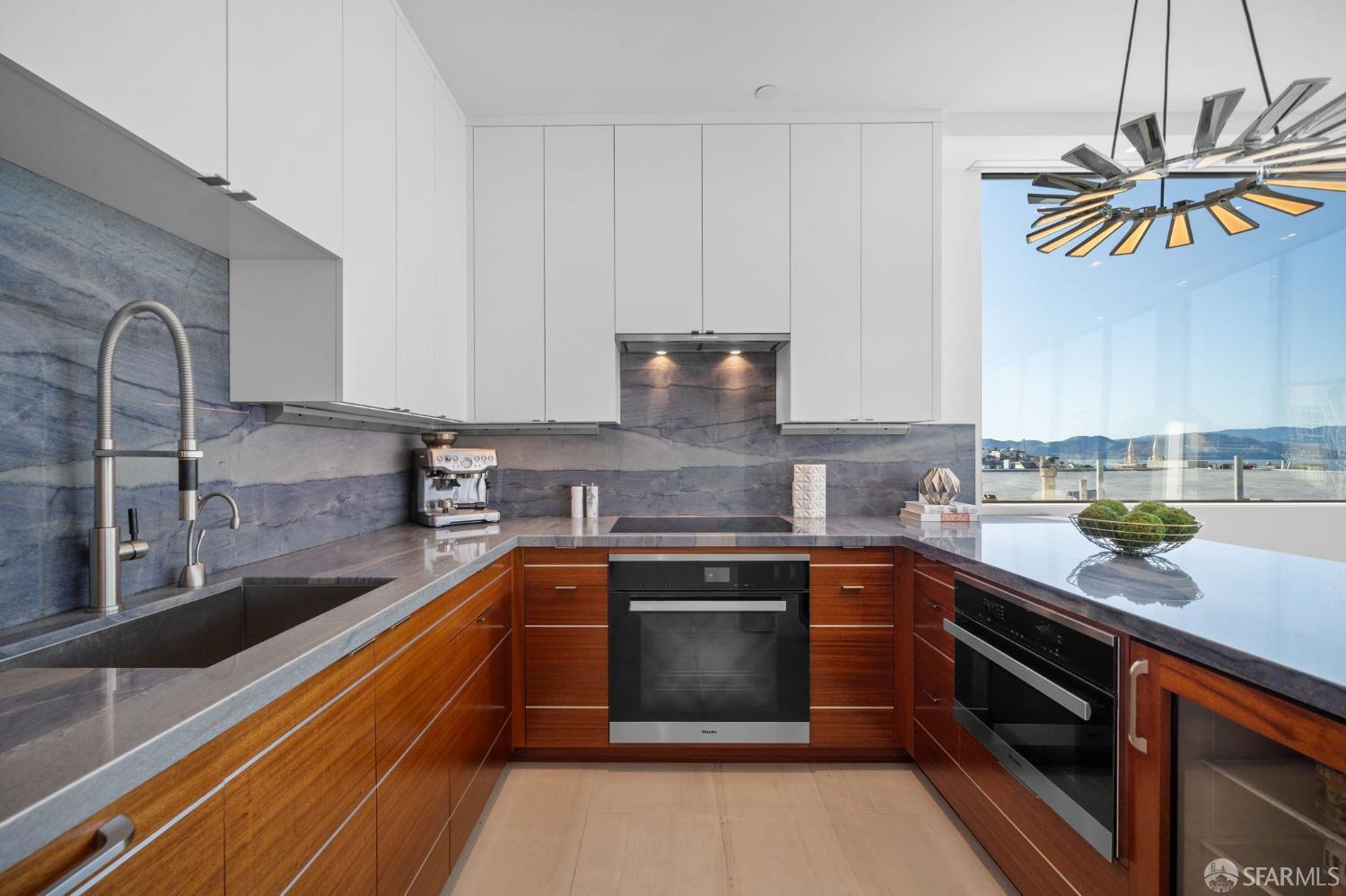 455 Vallejo Street, Unit PH6 San Francisco, CA 94133 - Photo 7 of 45 a kitchen with stainless steel appliances granite countertop a sink and cabinets