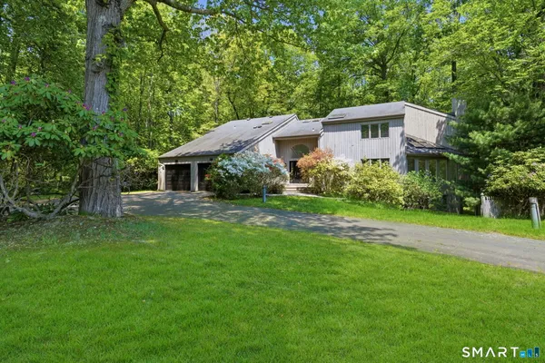 a front view of house with yard and green space