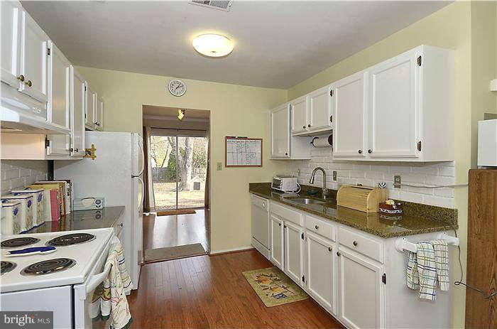 17205 Hoskinson Road Poolesville, MD 20837 - Photo 3 of 23 a kitchen with stainless steel appliances a stove a sink a refrigerator and cabinets