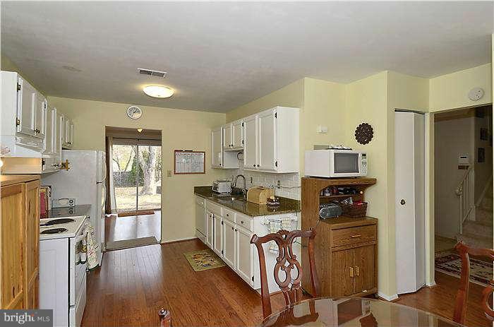17205 Hoskinson Road Poolesville, MD 20837 - Photo 5 of 23 a kitchen with stainless steel appliances granite countertop a stove a sink and a refrigerator