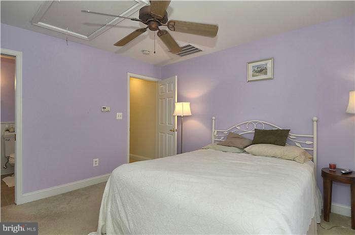 17205 Hoskinson Road Poolesville, MD 20837 - Photo 8 of 23 a bedroom with a bed and a chandelier