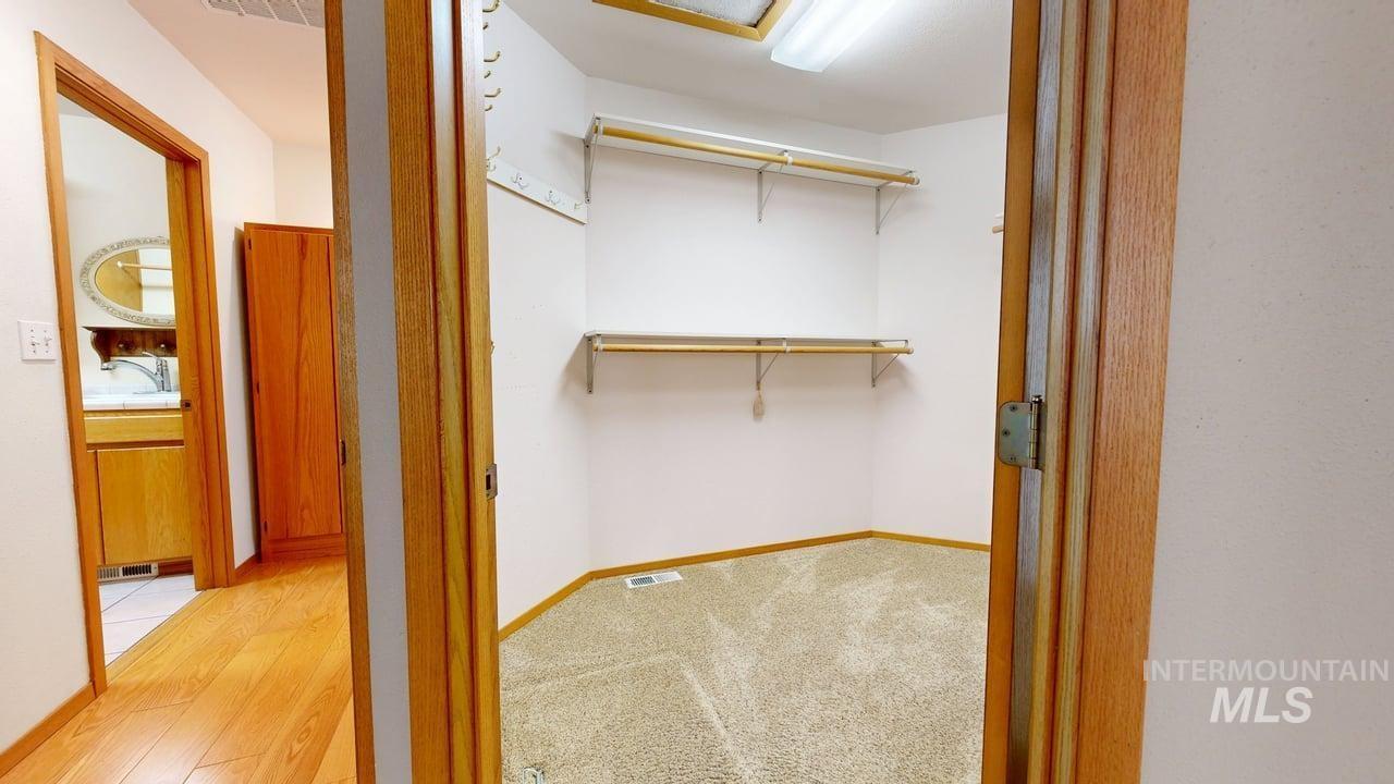 2794 9th Avenue Clarkston, WA 99403 - Photo 16 of 34 Walk in closet with attic access and light wood-style floors