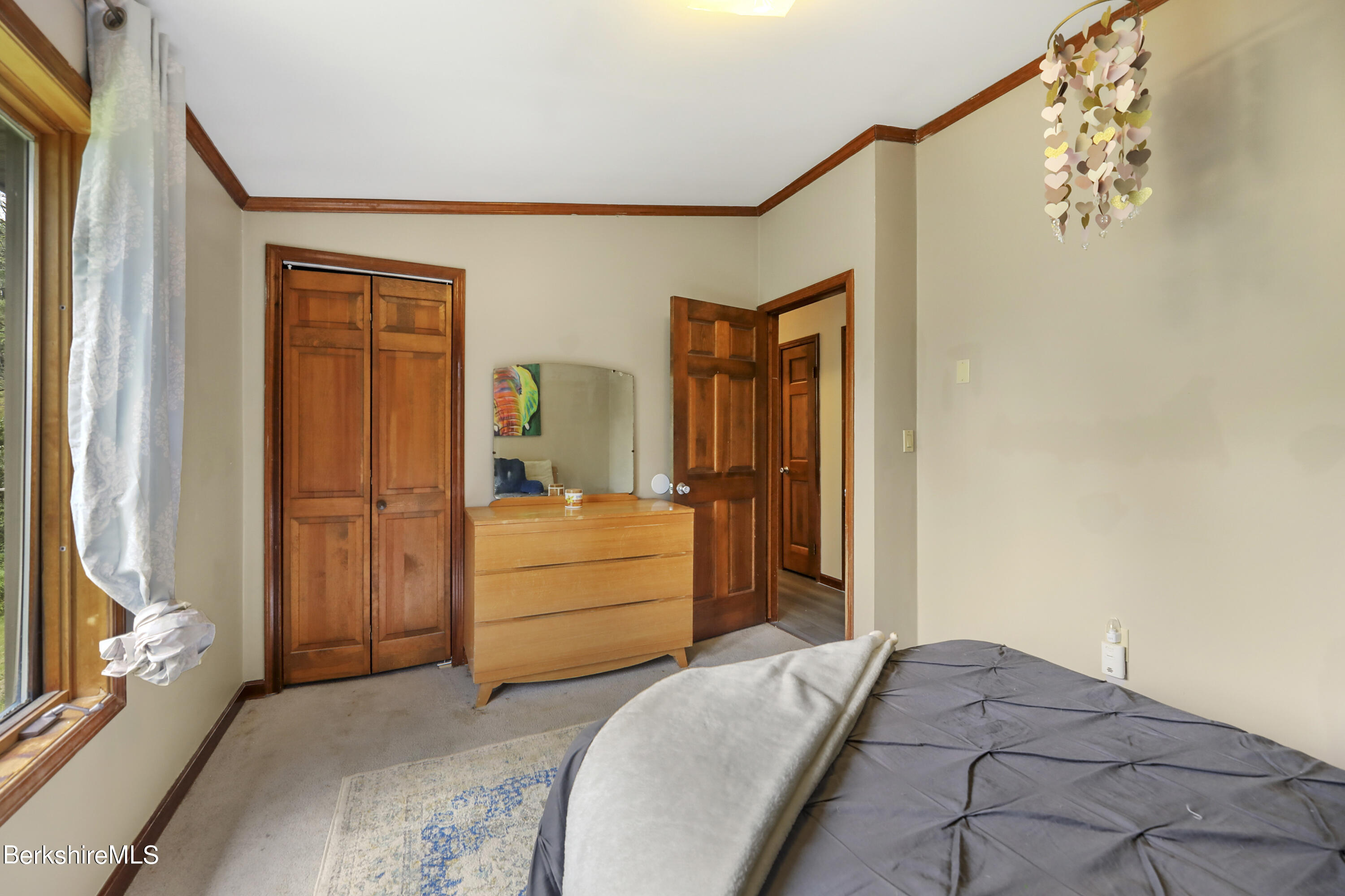 77 Shawnee Shore Road Becket, MA 01223 - Photo 13 of 28 a bedroom with a bed and a mirror