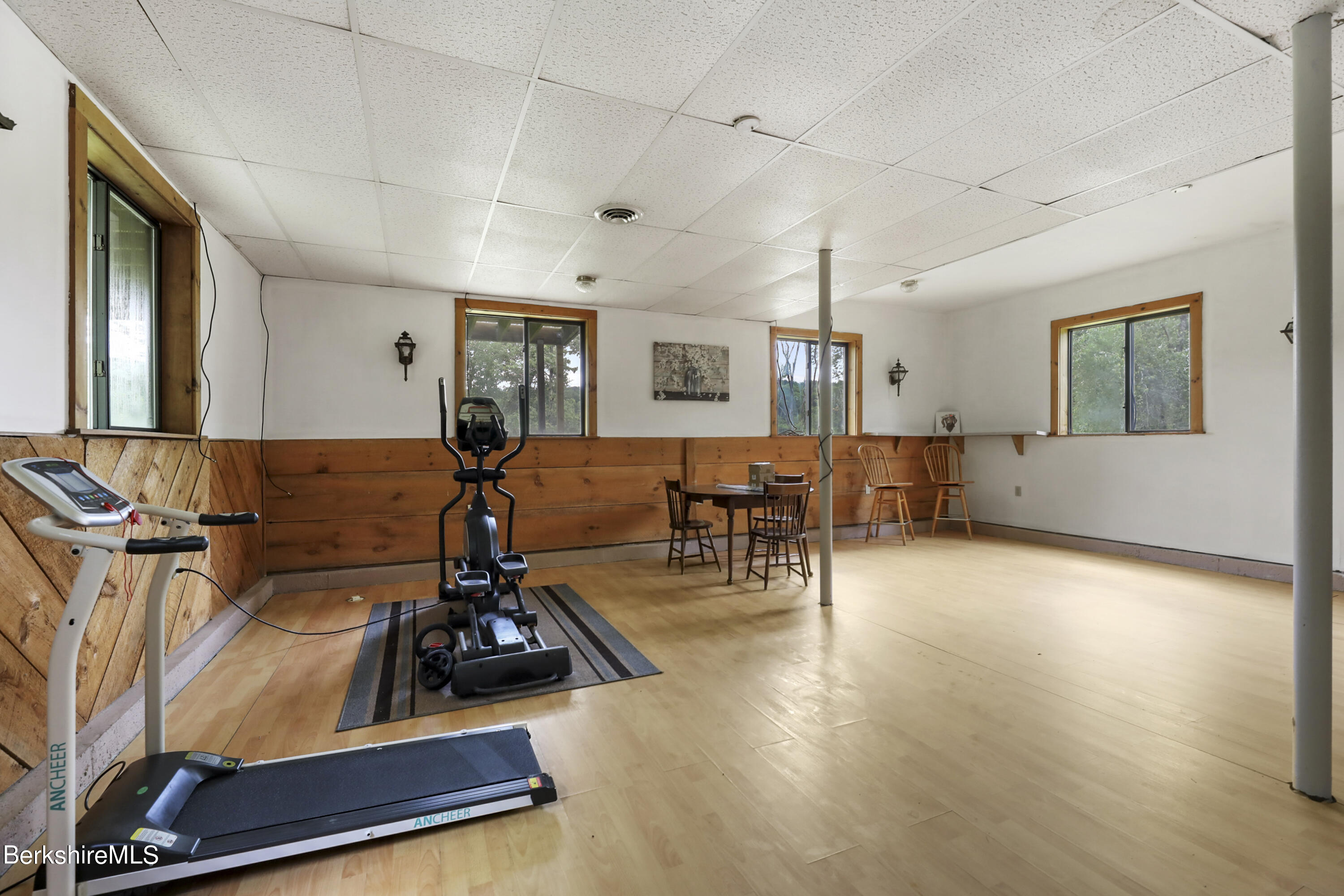 77 Shawnee Shore Road Becket, MA 01223 - Photo 19 of 28 a room with gym equipment and wooden floor