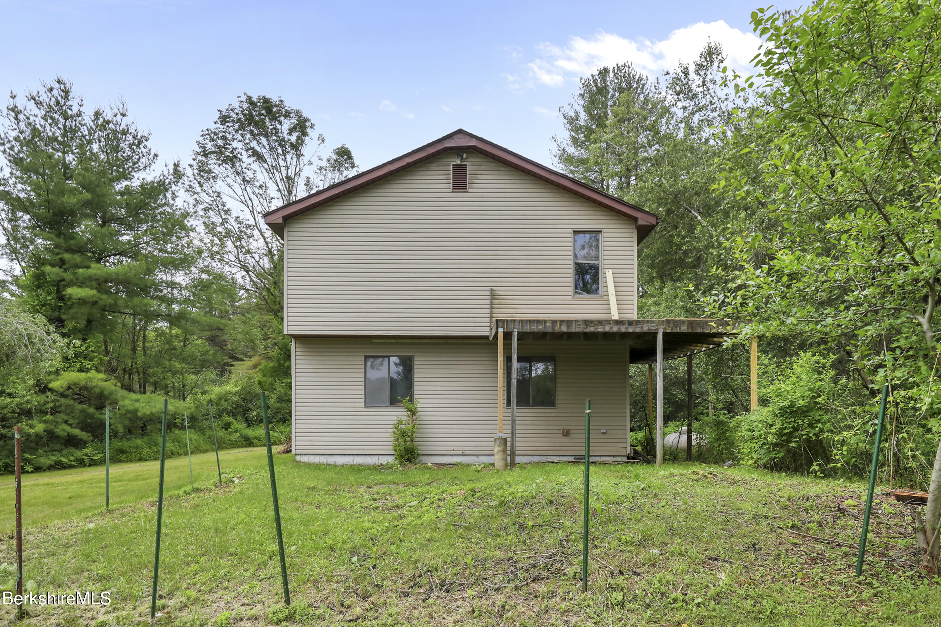 77 Shawnee Shore Road Becket, MA 01223 - Photo 23 of 28 a house view with a garden space