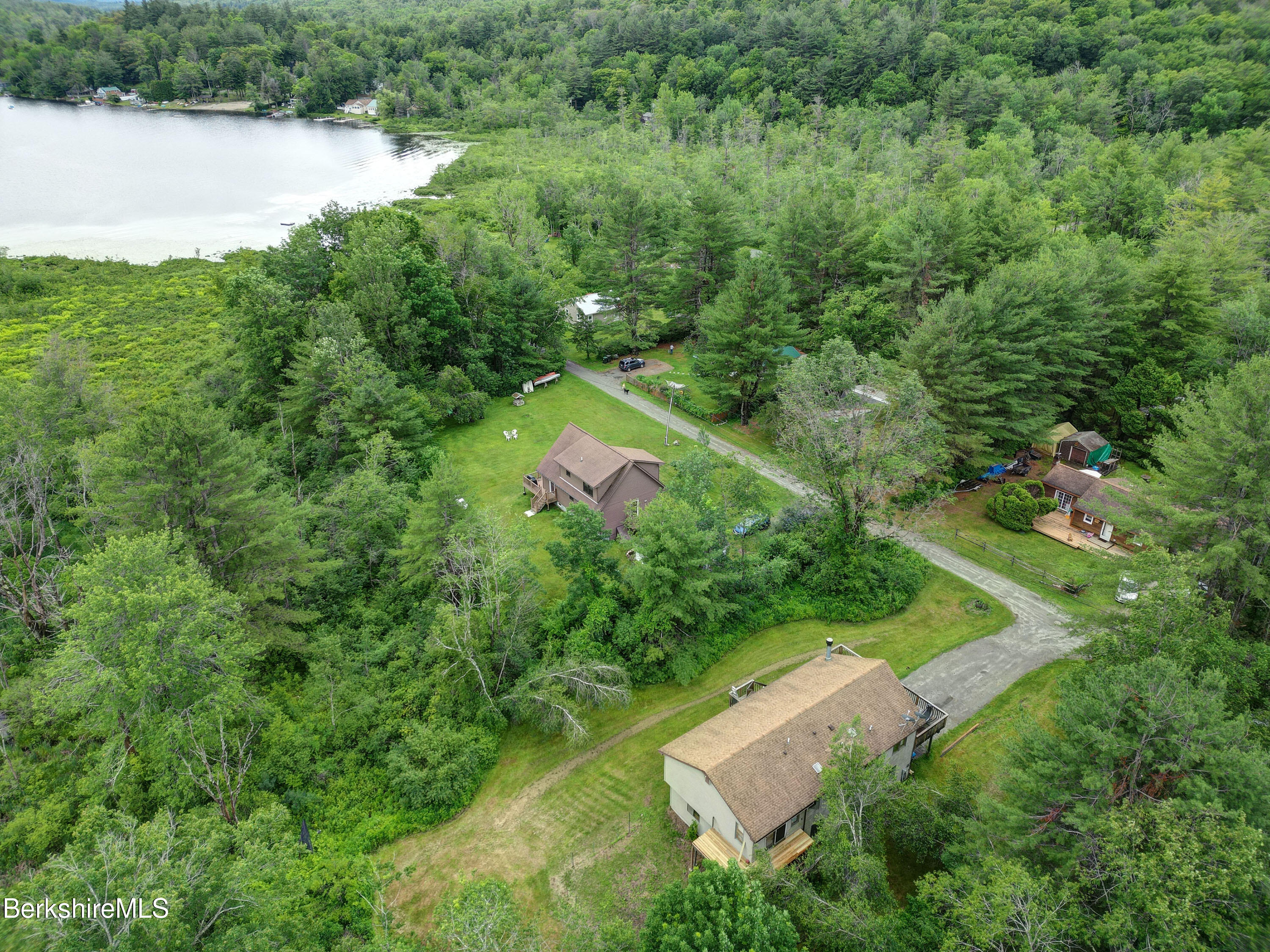 77 Shawnee Shore Road Becket, MA 01223 - Photo 26 of 28 an aerial view of residential house with outdoor space and trees all around