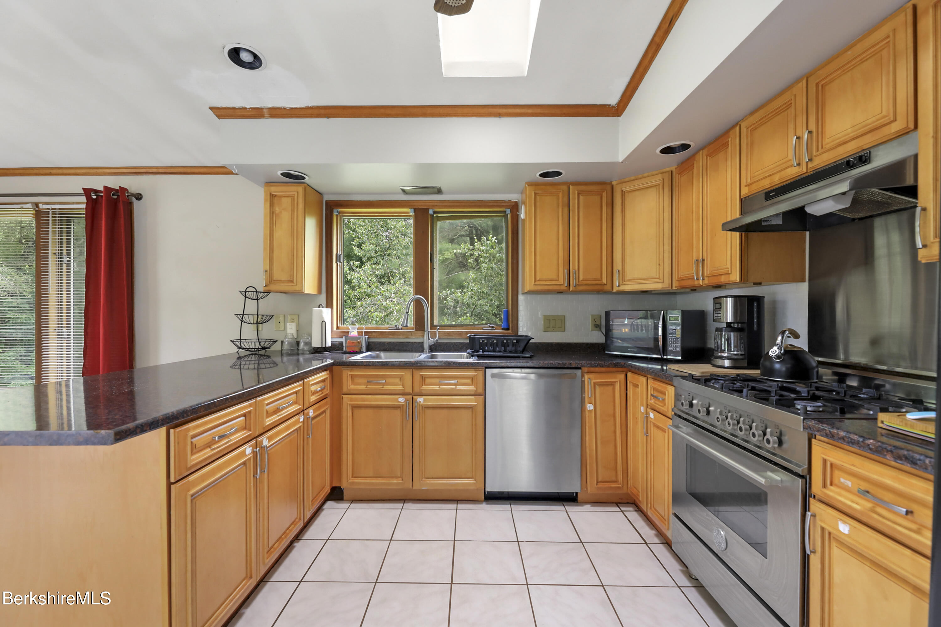 77 Shawnee Shore Road Becket, MA 01223 - Photo 9 of 28 a kitchen with stainless steel appliances a stove sink and cabinets