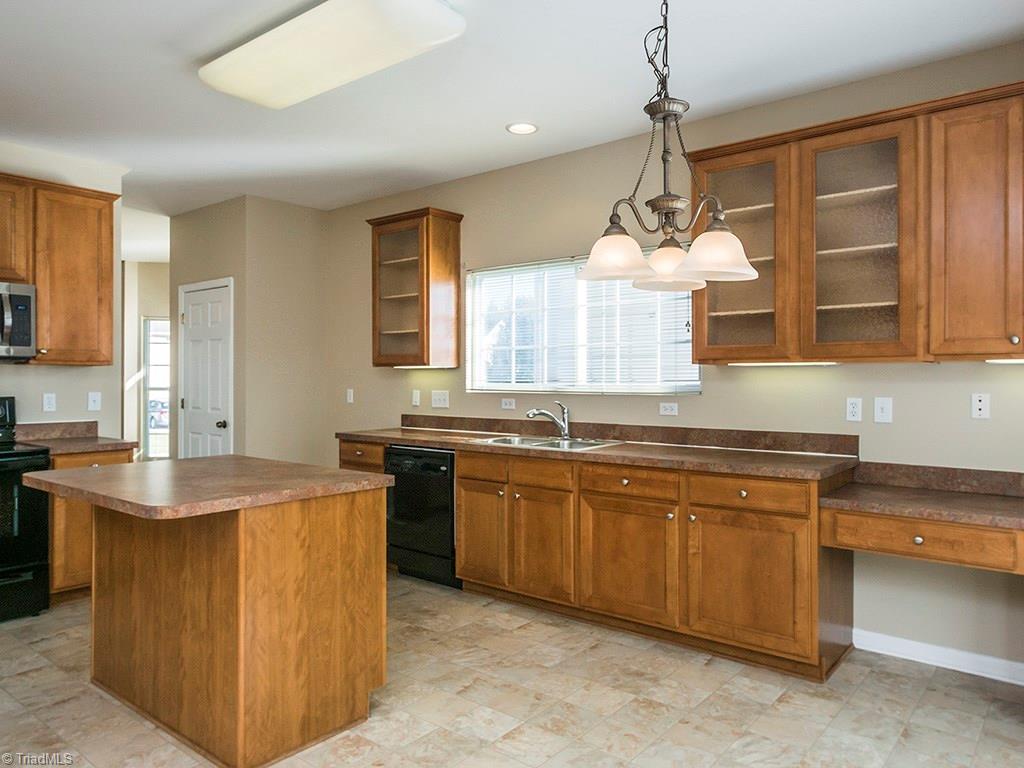 1309 Sharp Ridge Road Greensboro, NC 27406 - Photo 3 of 30 Giant Kitchen with tons of counterspace, All new appliances, 42" cabinents and desk area. This room opens to the den and pantry is in far right corner of the photo
