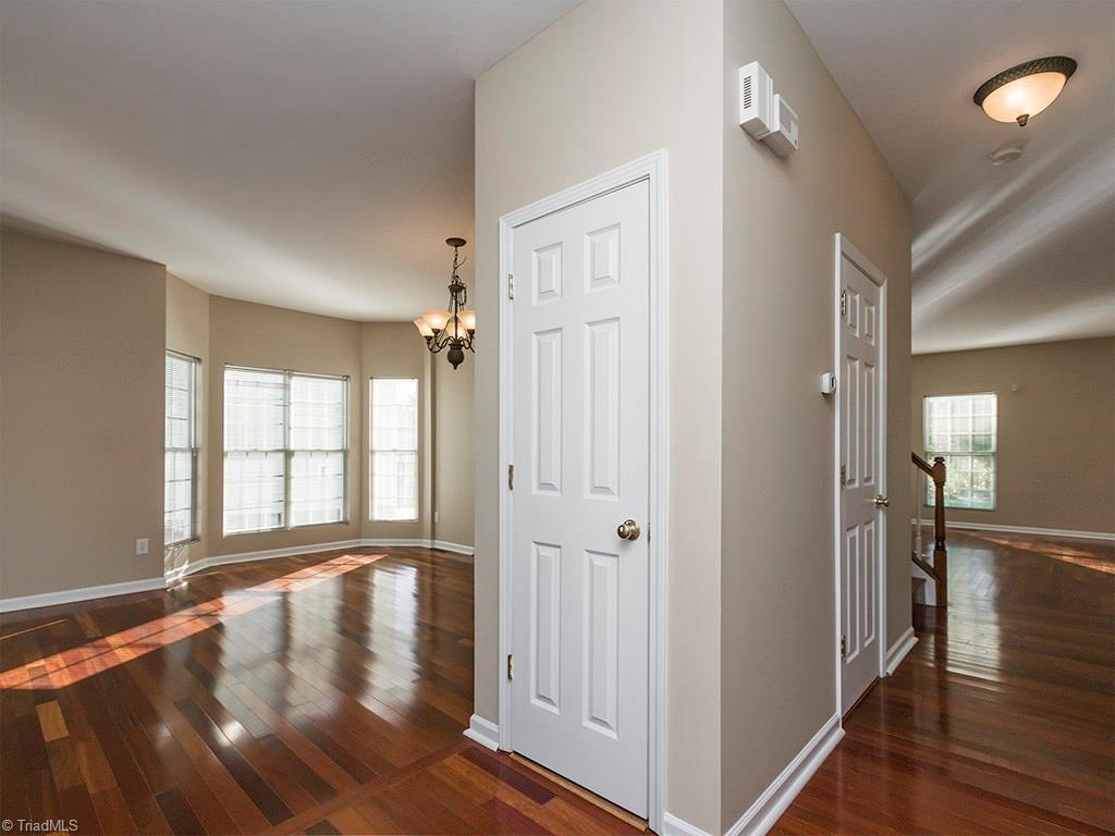 1309 Sharp Ridge Road Greensboro, NC 27406 - Photo 28 of 30 Dining room with 2 bay windows to the left and hallway leading to the den , 1/2 bath and stairs to the right