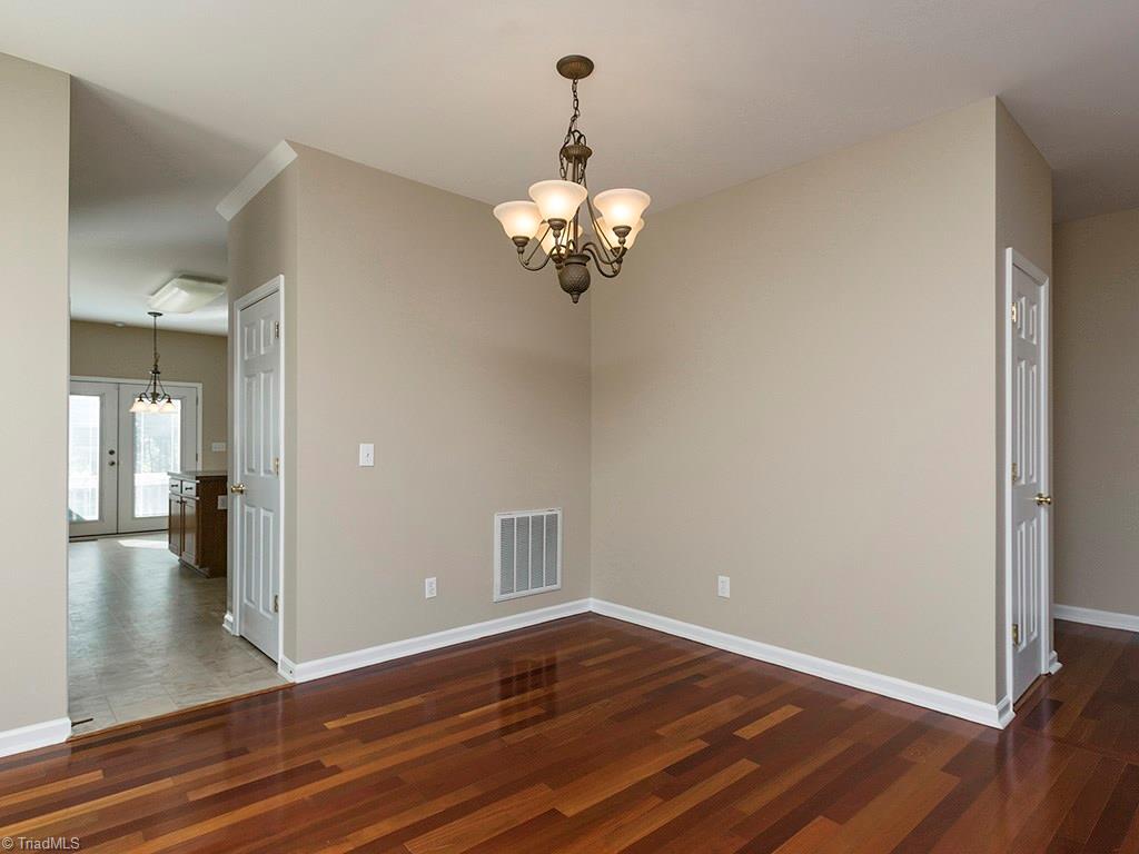 1309 Sharp Ridge Road Greensboro, NC 27406 - Photo 10 of 30 Dining room facing the kitchen, Coat closet is door to the right, Pantry is the door on the left