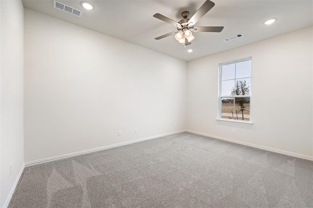 3107 White Oak Road Terrell, TX 75161 - Photo 11 of 40 an empty room with a window and a ceiling fan