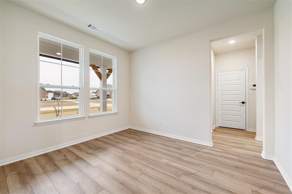 3107 White Oak Road Terrell, TX 75161 - Photo 12 of 40 a view of an empty room with wooden floor and a window