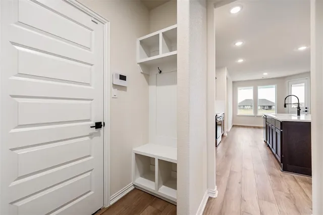a kitchen with a sink cabinets and wooden floor