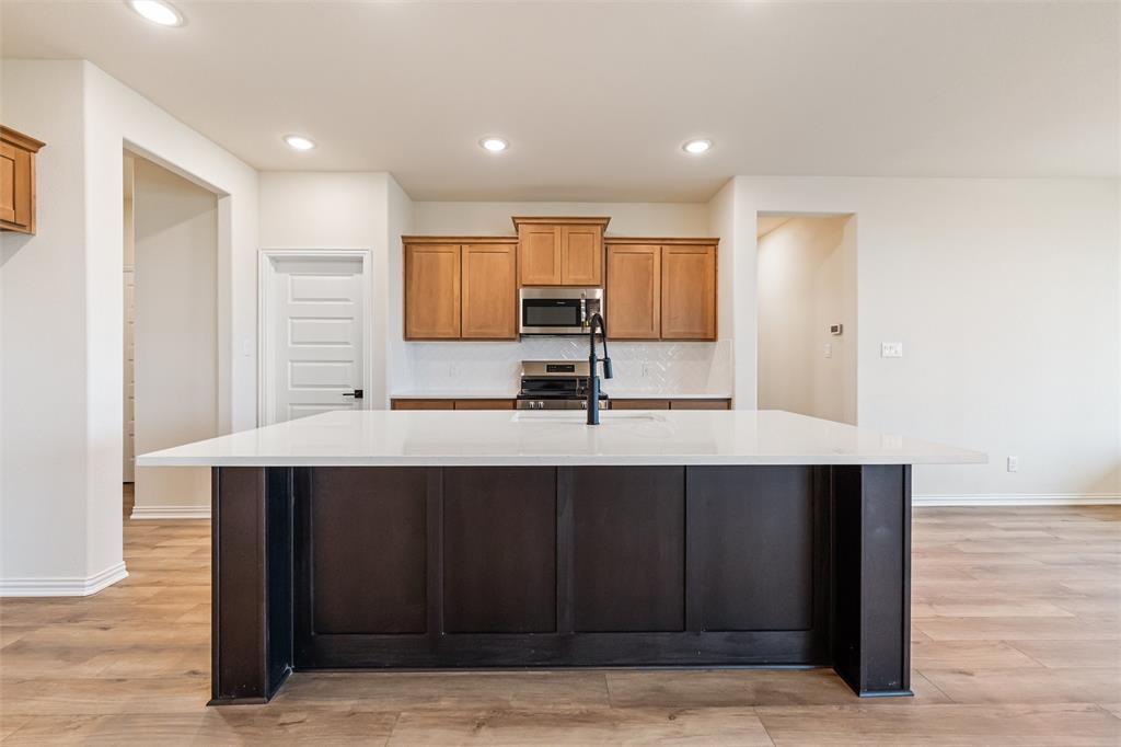 3107 White Oak Road Terrell, TX 75161 - Photo 15 of 40 a kitchen with a sink cabinets and wooden floor