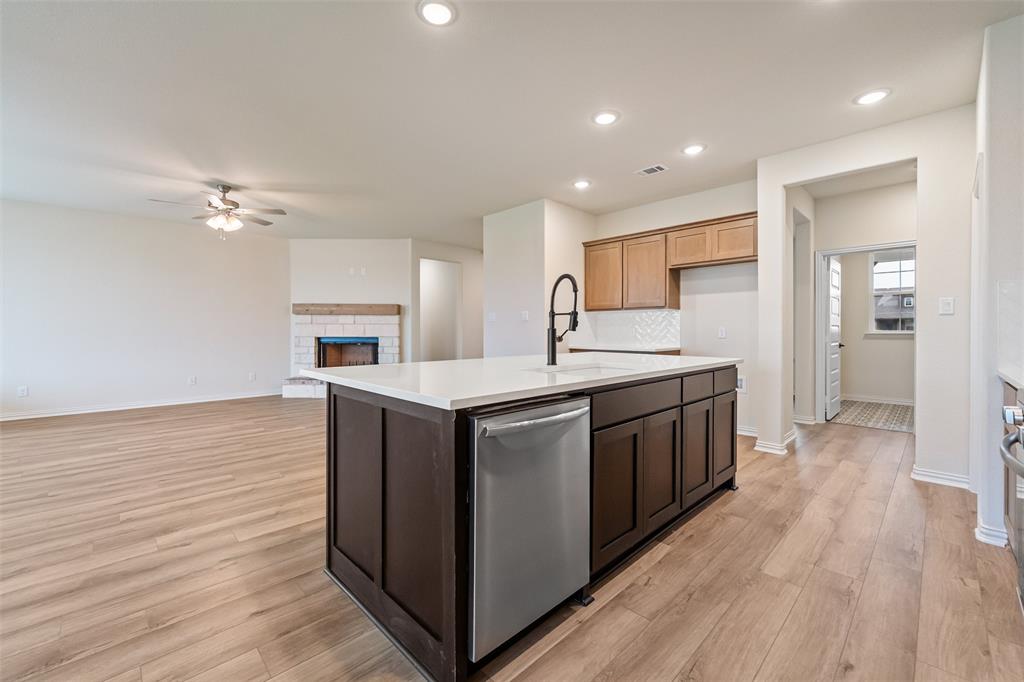 3107 White Oak Road Terrell, TX 75161 - Photo 17 of 40 a kitchen with kitchen island a sink appliances and cabinets