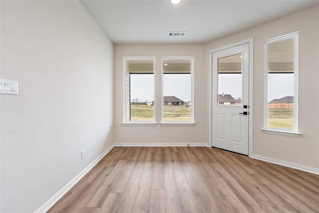 3107 White Oak Road Terrell, TX 75161 - Photo 19 of 40 an empty room with wooden floor and windows