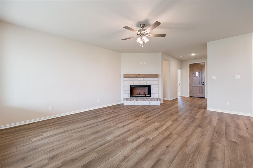 3107 White Oak Road Terrell, TX 75161 - Photo 20 of 40 a view of an empty room with wooden floor and a fireplace