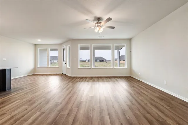 wooden floor in an empty room with a fireplace