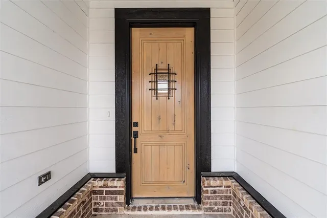 a view of a hallway with wooden floor and a cabinet