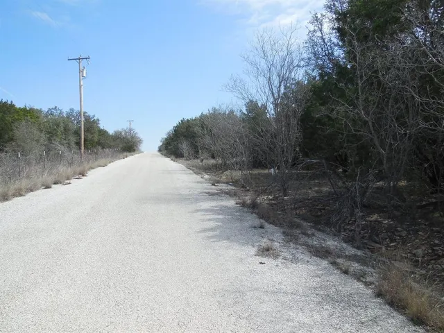 a view of a road with a dry yard
