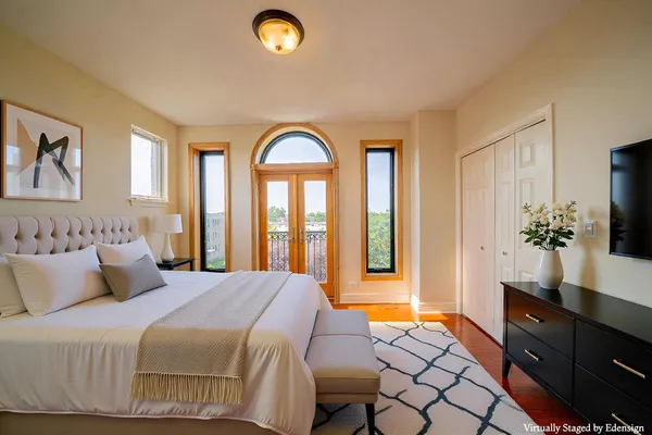 a bedroom with a bed and a flat screen tv