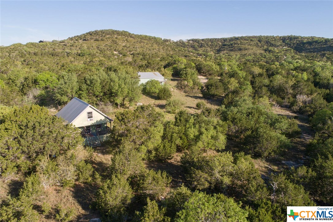 1800 Montell Road Wimberley, TX 78676 - Photo 1 of 1 a view of a lush green field with a mountain in the background
