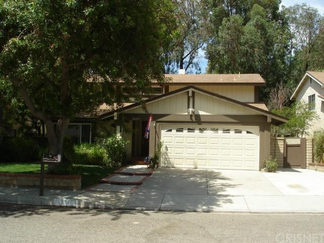 a front view of a house with a yard and a garage