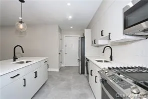a kitchen with sink a stove and appliances