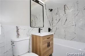 a bathroom with a sink a mirror and a toilet