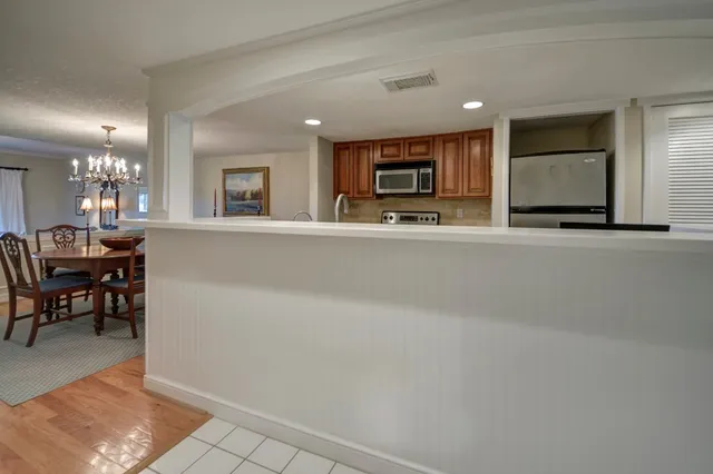 a view of a dining room with furniture and chandelier