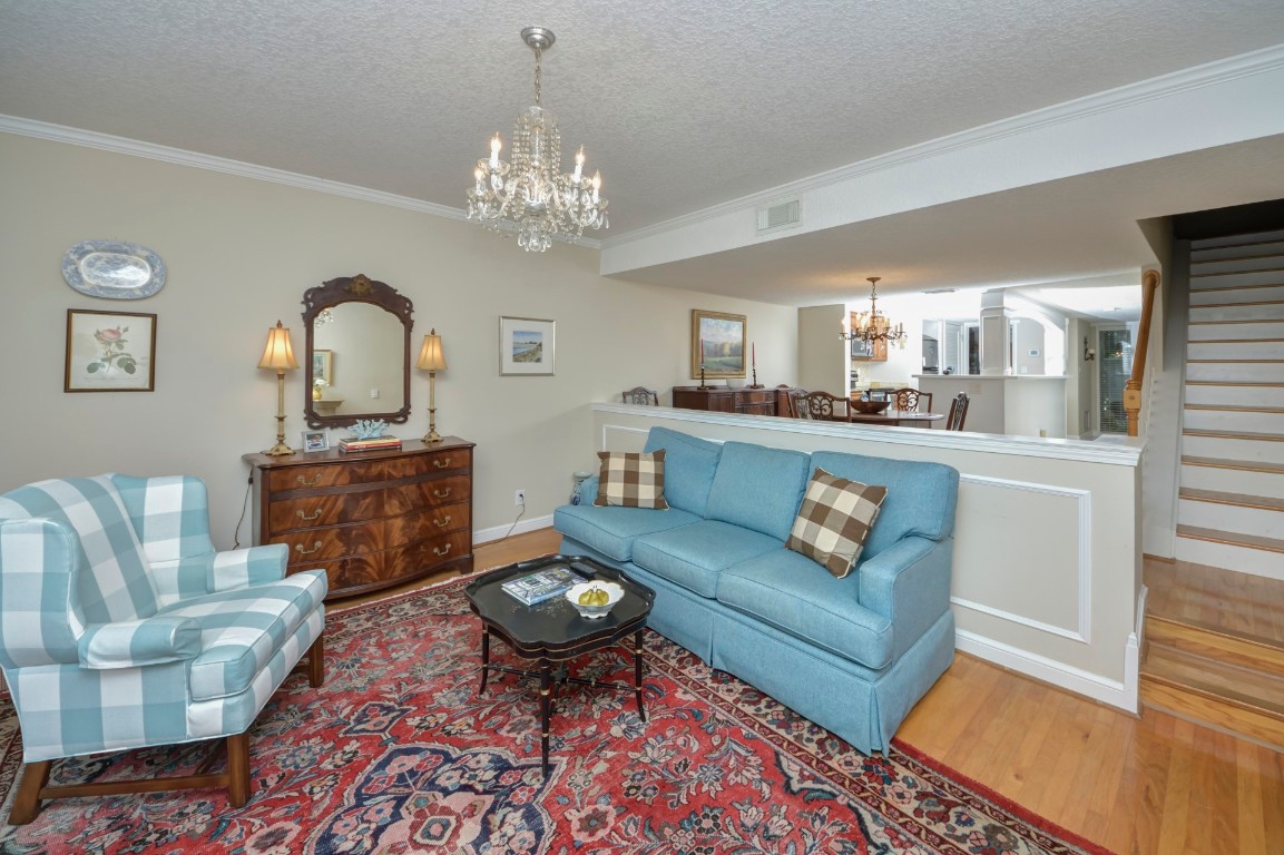 3052 Sea Marsh Road Fernandina Beach, FL 32034 - Photo 18 of 41 a living room with furniture a chandelier and a fireplace